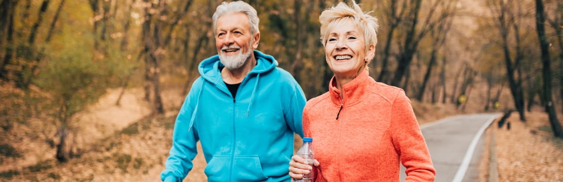Senior couple exercise race walking in a park